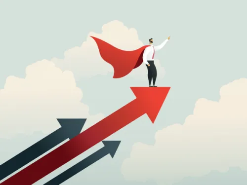 Person with a white shirt, tie, and black pants standing on upward pointing arrows in a cloud filled sky. They are wearing a red cape and pointing forward with their left hand.